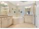 Elegant bathroom with a large soaking tub and double vanity at 6527 Moorings Point Cir # 101, Lakewood Ranch, FL 34202