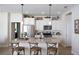 Modern kitchen with white cabinets, granite countertops, and island seating at 2471 W Price Blvd, North Port, FL 34286