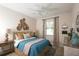 Bedroom with teal bedding and ceiling fan at 2471 W Price Blvd, North Port, FL 34286