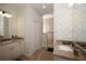 Double vanity bathroom with patterned wallpaper and walk-in shower at 2471 W Price Blvd, North Port, FL 34286