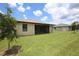 Large backyard with a screened patio and lush lawn at 2471 W Price Blvd, North Port, FL 34286