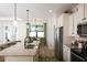 Open concept kitchen with island, granite counters & breakfast area at 2471 W Price Blvd, North Port, FL 34286