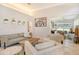 Living room with light walls, comfortable seating, and a view of the lanai at 3924 Alamanda Dr, Sarasota, FL 34238