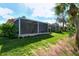 Screened patio with backyard view at 3924 Alamanda Dr, Sarasota, FL 34238