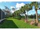 Landscaped backyard with pond view at 3924 Alamanda Dr, Sarasota, FL 34238