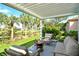 Relaxing patio with pergola overlooking pond at 3924 Alamanda Dr, Sarasota, FL 34238