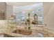 Kitchen features granite countertops, stainless steel sink, and a view into the living area at 3924 Alamanda Dr, Sarasota, FL 34238