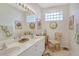 Double vanity bathroom with a glass block window, providing natural light and style at 3924 Alamanda Dr, Sarasota, FL 34238