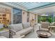 Outdoor patio with seating area and view into the living room at 3924 Alamanda Dr, Sarasota, FL 34238