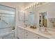 Double vanity bathroom with walk-in shower and access to the bedroom at 3924 Alamanda Dr, Sarasota, FL 34238