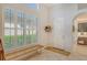Bright and airy entryway with a bench, large windows, and a white door at 3924 Alamanda Dr, Sarasota, FL 34238