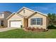 Tan house exterior with gray shutters and landscaped yard at 5240 11Th E St, Bradenton, FL 34203