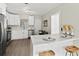 Modern kitchen with white cabinets, quartz countertops and stainless steel appliances at 1012 Myrtle Ave, Venice, FL 34285