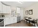 Modern white kitchen with stainless steel appliances and quartz countertops at 1012 Myrtle Ave, Venice, FL 34285