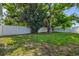 Large backyard with lush grass and a white fence at 1012 Myrtle Ave, Venice, FL 34285