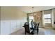 Dining room featuring a wood table, chandelier, and white wainscoting at 12661 Oak Hill Way, Parrish, FL 34219