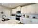 Modern kitchen with white shaker cabinets, quartz countertops, and stainless steel appliances at 12661 Oak Hill Way, Parrish, FL 34219