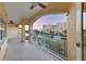 Spacious waterfront balcony featuring decorative tile, ceiling fan, and stunning views of the canal and neighborhood at 14041 Bellagio Way # 214, Osprey, FL 34229