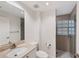 Modern bathroom with a shower, vanity with sink, mirror, toilet, and tile flooring at 14041 Bellagio Way # 214, Osprey, FL 34229