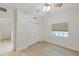 Bedroom featuring wood flooring, closet, and a window with blinds at 14041 Bellagio Way # 214, Osprey, FL 34229