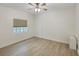 Bright bedroom with a ceiling fan, wood flooring, a window, and neutral walls at 14041 Bellagio Way # 214, Osprey, FL 34229