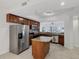 Modern kitchen featuring stainless steel appliances, granite countertops, and ample cabinet space at 14041 Bellagio Way # 214, Osprey, FL 34229