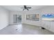 Open-plan living room includes access to a balcony, canal views, and neutral finishes at 14041 Bellagio Way # 214, Osprey, FL 34229