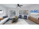 Bright living room showcases sliding doors, a view of the canal, and modern coastal furnishings at 14041 Bellagio Way # 214, Osprey, FL 34229
