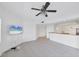 Living space with TV, tile flooring, and views of the kitchen with breakfast bar at 14041 Bellagio Way # 214, Osprey, FL 34229