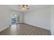 Bright primary bedroom includes a ceiling fan, balcony access, and neutral flooring at 14041 Bellagio Way # 214, Osprey, FL 34229