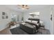 The main bedroom features wood-look flooring, a ceiling fan, a balcony door, and neutral finishes at 14041 Bellagio Way # 214, Osprey, FL 34229