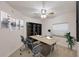 Home office with a desk, chairs, a bookshelf, and Golden Gate Bridge artwork at 14041 Bellagio Way # 214, Osprey, FL 34229
