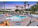 Community pool with lounge chairs, umbrellas, and tropical plants offers relaxing experience with beautiful twilight views at 14041 Bellagio Way # 214, Osprey, FL 34229