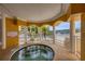 Relaxing community spa area with covered seating and views of the palm trees and marina at 14041 Bellagio Way # 214, Osprey, FL 34229
