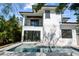 Modern home exterior with a pool and lush landscaping in the backyard at 2318 Bay St, Sarasota, FL 34237