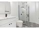 Stylish bathroom featuring patterned tile floors, a glass-enclosed shower, and modern fixtures at 2318 Bay St, Sarasota, FL 34237
