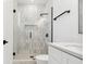 Modern bathroom featuring a glass shower with white tile, black hardware and vanity at 2318 Bay St, Sarasota, FL 34237