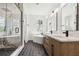 Modern bathroom with a glass-enclosed shower, a soaking tub, and a double sink vanity at 2318 Bay St, Sarasota, FL 34237