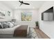 Large bedroom with bed, large windows, mounted TV and light hardwood flooring at 2318 Bay St, Sarasota, FL 34237