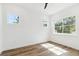 Bright bedroom with three large windows, light walls, and hardwood floors at 2318 Bay St, Sarasota, FL 34237
