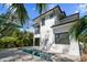 A modern home with clean lines, complemented by a sleek in-ground pool and lush landscaping at 2318 Bay St, Sarasota, FL 34237