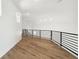 Upstairs hallway with wood floors and black handrails at 2318 Bay St, Sarasota, FL 34237