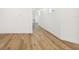 Spacious hallway featuring new hardwood flooring and fresh white walls with natural light at 2318 Bay St, Sarasota, FL 34237