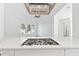Bright, modern kitchen with a cooktop island, stainless steel vent hood, and light countertops at 2318 Bay St, Sarasota, FL 34237
