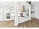Open concept kitchen featuring white cabinets, stainless steel appliances, a large island and wood floors at 2318 Bay St, Sarasota, FL 34237
