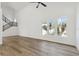 Bright, airy living room featuring wood floors, a modern staircase, and large windows for lots of natural light at 2318 Bay St, Sarasota, FL 34237