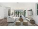 Bright and airy living room with stylish furniture, hardwood floors, and large sliding glass doors to the backyard at 2318 Bay St, Sarasota, FL 34237