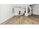 Open-concept living space with light wood floors, white walls, and modern kitchen featuring stainless steel appliances at 2318 Bay St, Sarasota, FL 34237