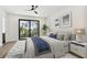 Primary bedroom with a ceiling fan, exterior access to a patio, and an ensuite bathroom at 2318 Bay St, Sarasota, FL 34237