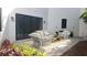 Cozy outdoor patio featuring a wicker furniture set, rug, and plants on a paved surface with sliding glass doors at 2318 Bay St, Sarasota, FL 34237